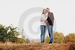 Beautiful young couple walking in autumn park