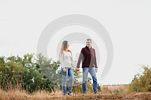 Beautiful young couple walking in autumn park