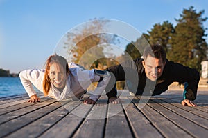 Beautiful young couple working out outside