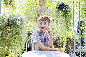 Beautiful young customer selecting fresh flowers in Parisian flower shop or on market