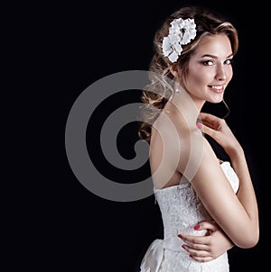 Beautiful young elegant happy smiling woman with red lips, beautiful stylish hairstyle with white flowers in her hair