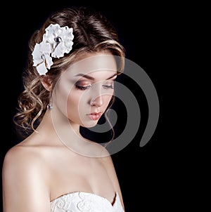 Beautiful young elegant happy smiling woman with red lips, beautiful stylish hairstyle with white flowers in her hair