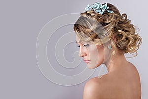 Beautiful young elegant sweet girl in the image of a bride with hair and flowers in her hair , delicate wedding makeup