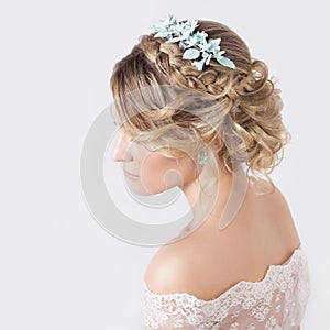 Beautiful young elegant sweet girl in the image of a bride with hair and flowers in her hair , delicate wedding makeup