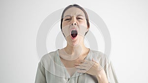 Beautiful young elegant woman over isolated background bored yawning tired covering mouth with hand. Restless and sleepiness.