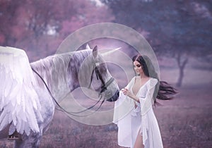 Beautiful, young elf, walking with a unicorn. She is wearing an incredible light, white dress. Art hotography