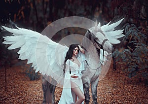 Beautiful, young elf, walking with a unicorn. She is wearing an incredible light, white dress. Art hotography