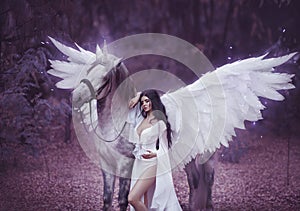 Beautiful, young elf, walking with a unicorn. She is wearing an incredible light, white dress. Art hotography