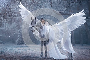 Beautiful, young elf, walking with a unicorn. She is wearing an incredible light, white dress. The girl lies on the horse. Sleepin