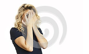 Beautiful young emotional girl closes her eyes to an isolated white background. Do not want to see