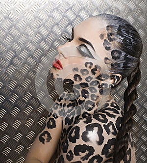 Beautiful young european model in cat make-up and bodyart