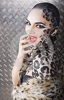 Beautiful young european model in cat make-up and bodyart