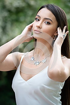 Beautiful young european woman with elegant earrings and necklace