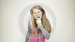 Beautiful young expression girl singing in microphone