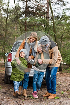 beautiful young family with car spending time