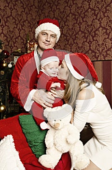 Beautiful young family with little cute baby girl on Christmas