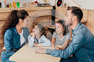 beautiful young family playing guess sticker