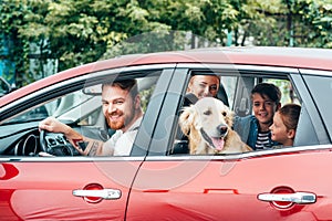 beautiful young family travelling by car photo