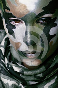 Beautiful young fashion woman with military style clothing and face paint make-up