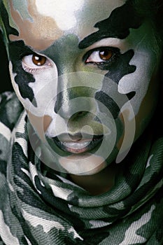 Beautiful young fashion woman with military style clothing and face paint make-up