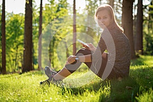 Beautiful young female athlete using fitness app on her smart watch to monitor workout performance. Lifestyle wearable technology.