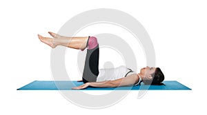 Beautiful young female exercising on a blue matt photo