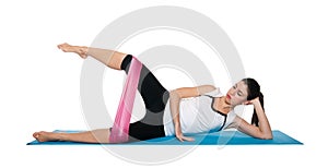 Beautiful young female exercising on a blue matt