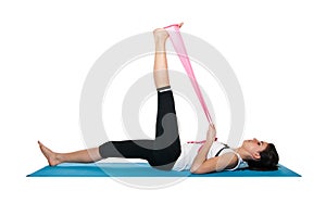 Beautiful young female exercising on a blue matt photo