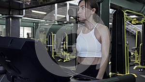 Beautiful Young Female Fitnes Model Is Running On A Treadmill