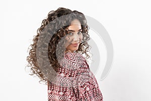 A beautiful young female model with curly long dark hair