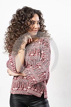 A beautiful young female model with curly long dark hair