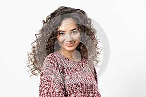 A beautiful young female model with curly long dark hair