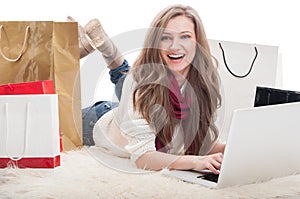 Beautiful and young female shopper using laptop