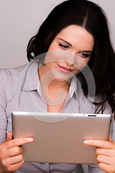 Beautiful young female using an ipad tablet device