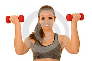 Beautiful young fit woman works out with dumbbells isolated over white background