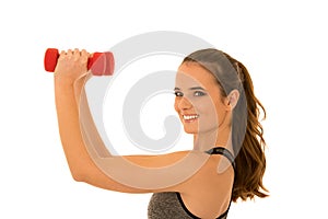 Beautiful young fit woman works out with dumbbells isolated over white background