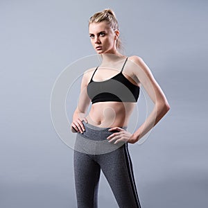 Beautiful young fitness woman wearing sport clothes posing