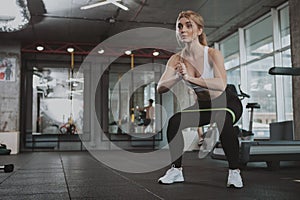 Beautiful young fitness woman working out at the gym