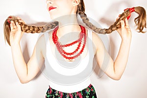 A beautiful young folk woman presents her long tresses photo