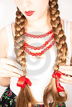 A beautiful young folk woman presents her long tresses photo