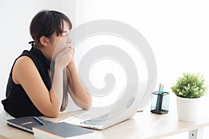 Beautiful young freelance asian woman working bored and tired on laptop computer at the office