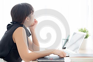 Beautiful young freelance asian woman working bored and tired on laptop computer at the office, girl lazy sleepy and yawning