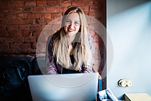 Beautiful Young Freelancer Woman Using Laptop Computer Sitting At Cafe Table. Happy Smiling Girl Working Online Or Studying And Le