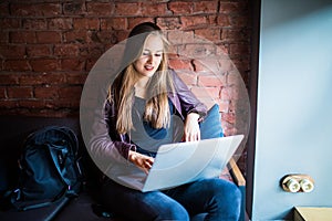 Beautiful Young Freelancer Woman Using Laptop Computer Sitting At Cafe Table. Happy Smiling Girl Working Online Or Studying And Le