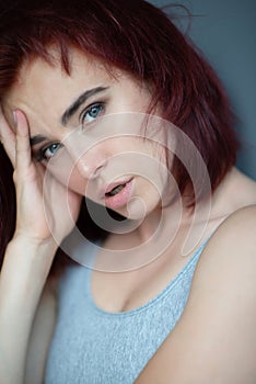 Beautiful young ginger woman with freckles. Fashion portrait of charming girl wearing casual clothes posing at home