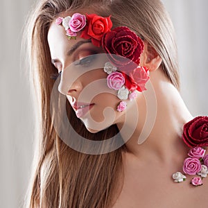 Beautiful young girl with applique flowers on the face.