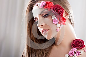 Beautiful young girl with applique flowers on the face.