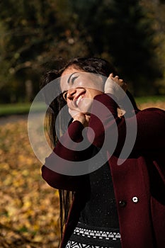 Beautiful young girl in the autumn forest on a sunny day
