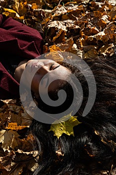 Beautiful young girl in the autumn forest on a sunny day