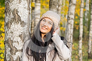 Beautiful young girl in the autumn forest on a sunny day